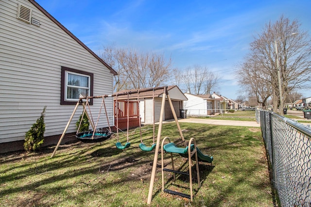 26410 Beverly Rd, Taylor, MI 48180 - view of yard with a playground, a residential view, a garage, and concrete driveway