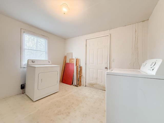 washroom with washing machine and dryer, laundry area, and light colored carpet