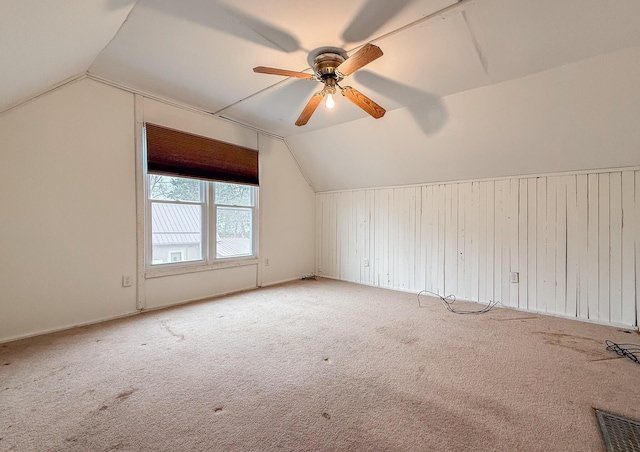 bonus room featuring lofted ceiling, visible vents, carpet floors, and a ceiling fan