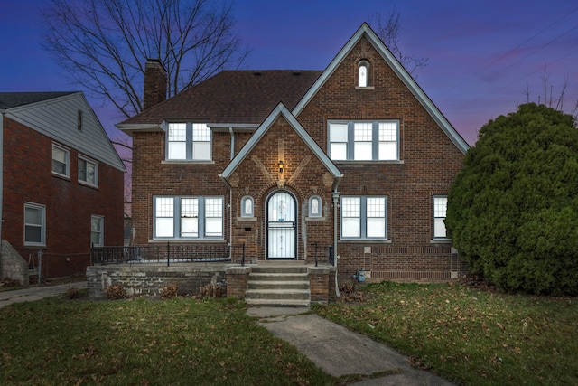 5959 Three Mile Dr, Detroit, MI 48224 - english style home with brick siding, a front yard, and a chimney