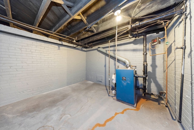 5959 Three Mile Dr, Detroit, MI 48224 - unfinished basement featuring a heating unit and brick wall