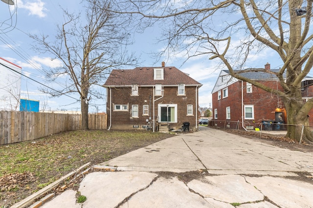 5959 Three Mile Dr, Detroit, MI 48224 - back of house featuring a chimney, brick siding, and fence private yard