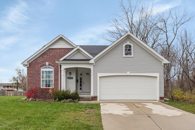 33172 Swallow Dr, Rockwood, MI 48173 - view of front of home featuring a front lawn, brick siding, roof with shingles, and driveway