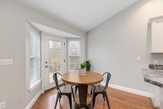 33172 Swallow Dr, Rockwood, MI 48173 - dining space featuring baseboards, lofted ceiling, and light wood-type flooring