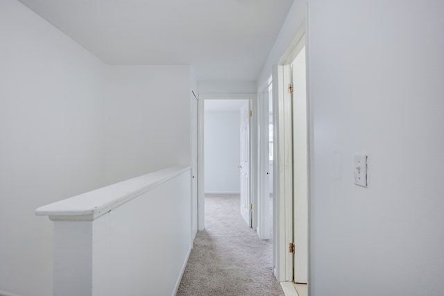 hallway with light colored carpet