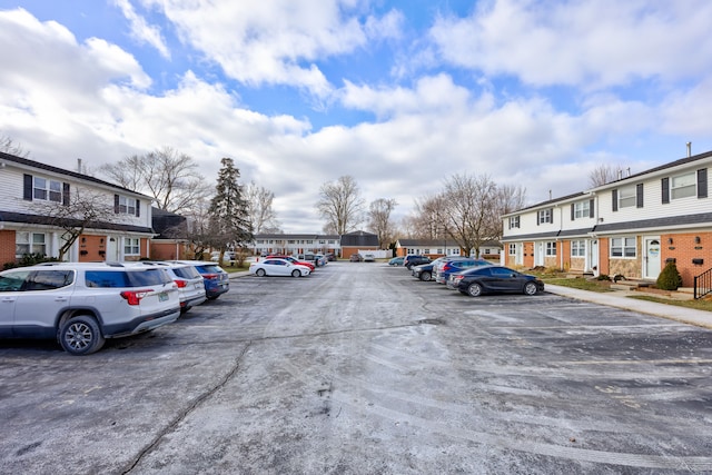 uncovered parking lot featuring a residential view
