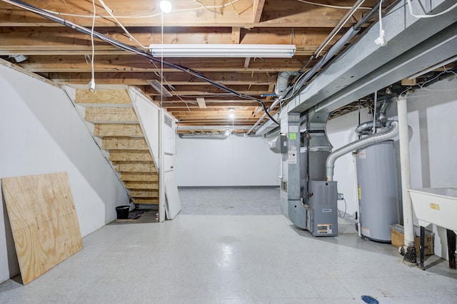 unfinished basement with heating unit, tile patterned floors, stairway, and gas water heater