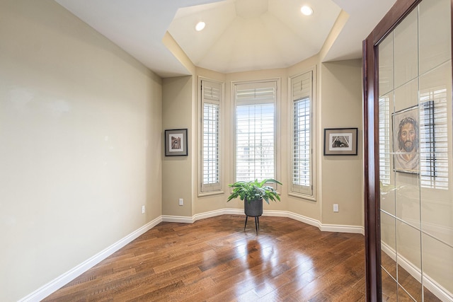 interior space with baseboards, wood finished floors, and recessed lighting