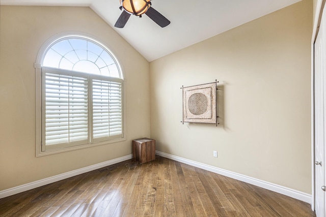 unfurnished room featuring wood finished floors, baseboards, vaulted ceiling, and ceiling fan