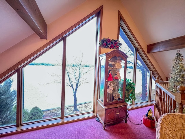 interior space with carpet flooring and beamed ceiling