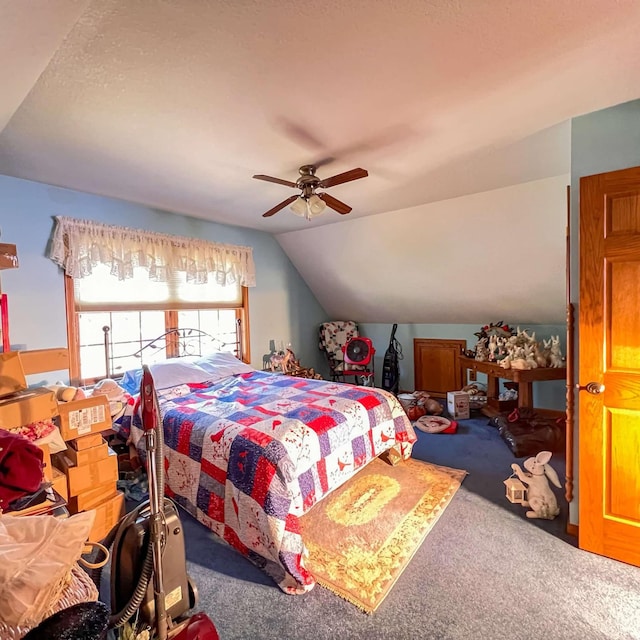 carpeted bedroom featuring a ceiling fan and vaulted ceiling