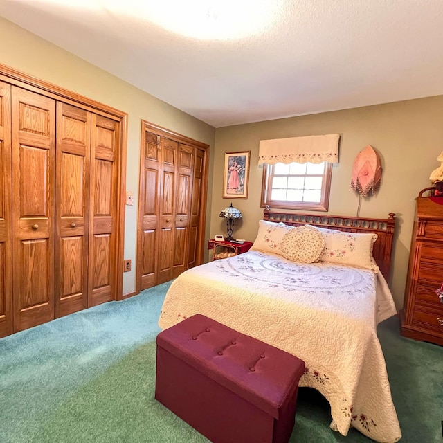 bedroom with carpet flooring and two closets