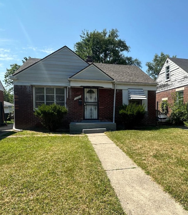 20561 Alcoy St, Detroit, MI 48205 - bungalow-style home with brick siding and a front lawn