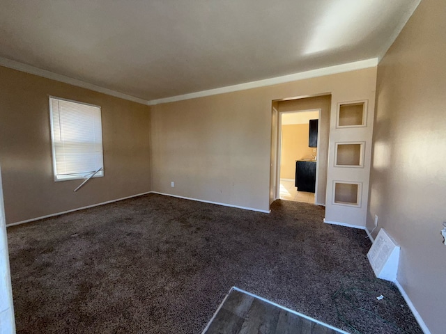20561 Alcoy St, Detroit, MI 48205 - spare room with baseboards, ornamental molding, dark carpet, and visible vents