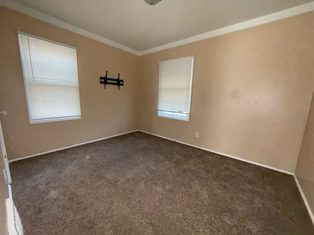 20561 Alcoy St, Detroit, MI 48205 - spare room with baseboards, ornamental molding, and dark carpet