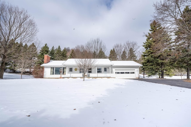 single story home featuring driveway, a garage, and a chimney