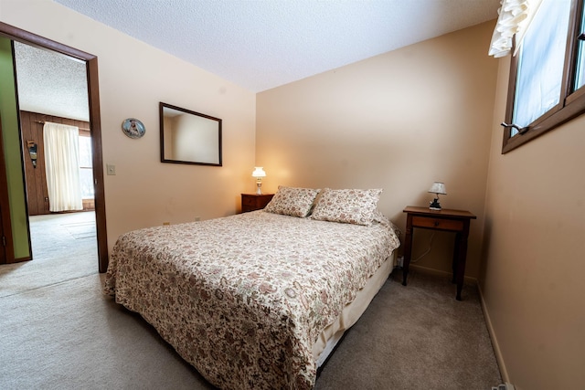 carpeted bedroom with baseboards and a textured ceiling