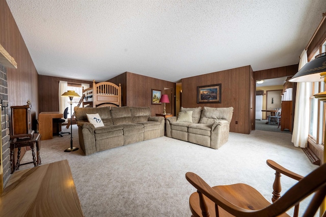 living room with wood walls, carpet floors, and a textured ceiling
