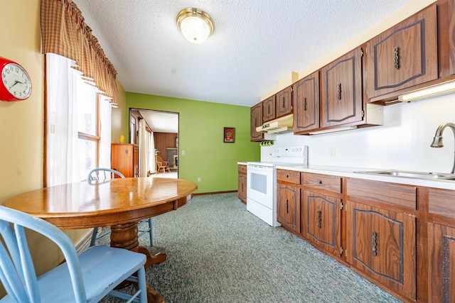 kitchen featuring light countertops, white range with electric stovetop, carpet, under cabinet range hood, and a sink