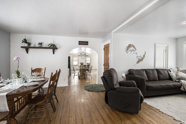 31585 Michigan Ave, Leonidas, MI 49066 - living area with arched walkways, baseboards, dark wood finished floors, and a wealth of natural light