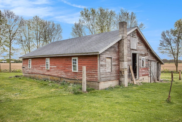 31585 Michigan Ave, Leonidas, MI 49066 - view of home's exterior featuring a yard, a barn, a chimney, and a shingled roof