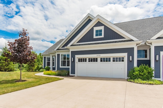 3733 Wetherington, Kalamazoo, MI 49006 - view of front of home with a garage, concrete driveway, board and batten siding, and a front yard
