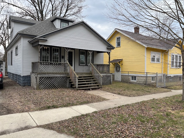 1720 White St, Port Huron, MI 48060 - bungalow with a porch, roof with shingles, and a gate