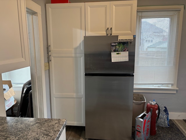 1720 White St, Port Huron, MI 48060 - kitchen featuring freestanding refrigerator, white cabinets, dark wood-type flooring, and baseboards