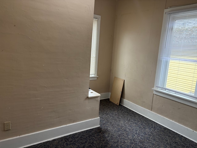 1720 White St, Port Huron, MI 48060 - unfurnished room with plenty of natural light, dark colored carpet, and baseboards