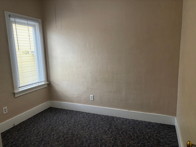 1720 White St, Port Huron, MI 48060 - empty room featuring dark carpet and baseboards