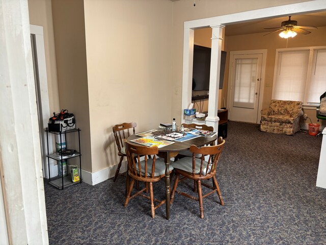 1720 White St, Port Huron, MI 48060 - dining area with ornate columns, carpet, a ceiling fan, and baseboards