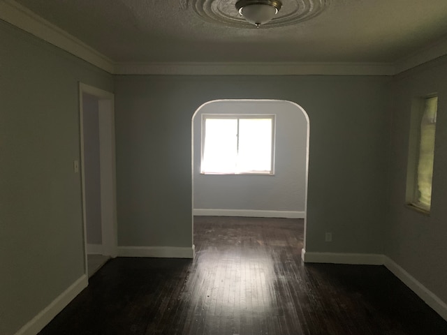14839 Rutherford St, Detroit, MI 48227 - spare room with a textured ceiling, baseboards, ornamental molding, arched walkways, and dark wood-style floors