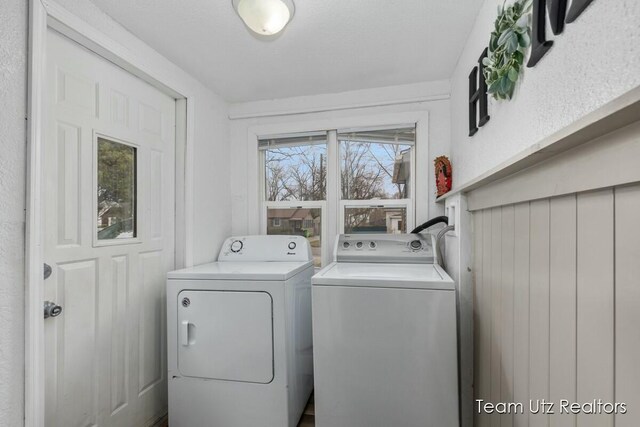 washroom featuring washer and clothes dryer and laundry area