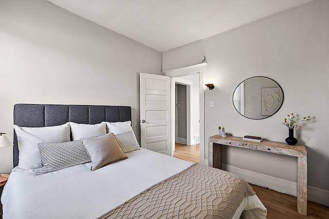 bedroom with wood finished floors and baseboards