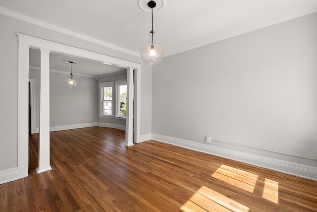 unfurnished room with crown molding, wood-type flooring, and baseboards