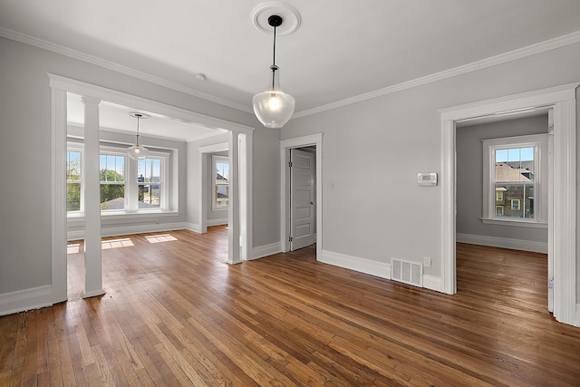 unfurnished dining area with hardwood / wood-style floors, baseboards, and ornamental molding