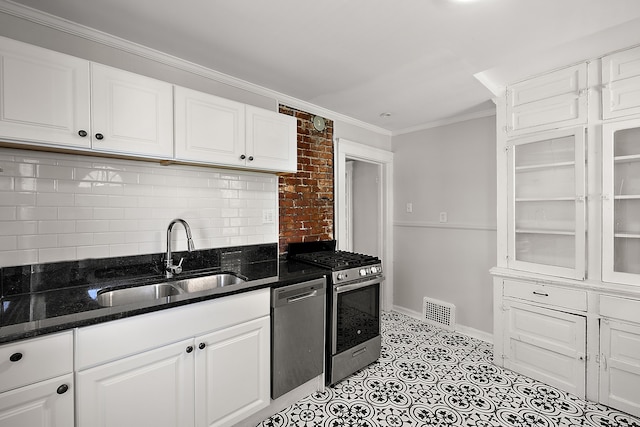 kitchen with appliances with stainless steel finishes, a sink, decorative backsplash, ornamental molding, and white cabinets