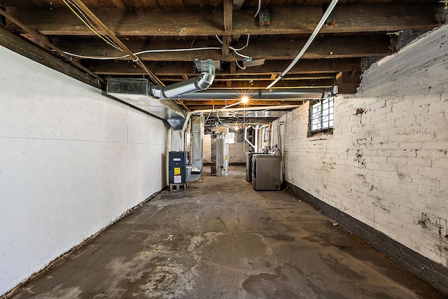 basement with washer / dryer, gas water heater, and heating unit