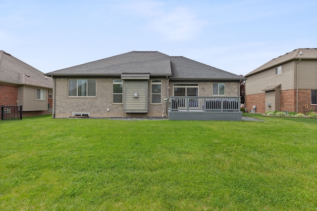 18277 Crenshaw Dr, Macomb, MI 48042 - back of house with brick siding, a wooden deck, a yard, and roof with shingles