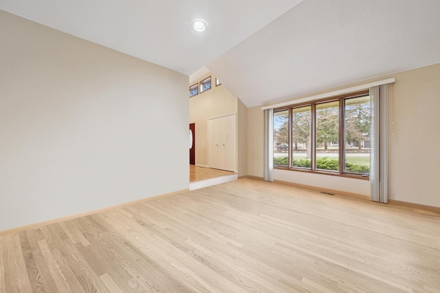 7465 Westbury Blvd, West Bloomfield, MI 48322 - unfurnished living room with light wood-style floors, baseboards, and high vaulted ceiling