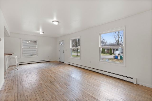 142 E Glass Rd, Ortonville, MI 48462 - interior space featuring a baseboard radiator, baseboards, and wood-type flooring