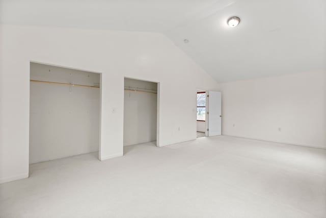 142 E Glass Rd, Ortonville, MI 48462 - unfurnished bedroom with two closets, light carpet, and high vaulted ceiling
