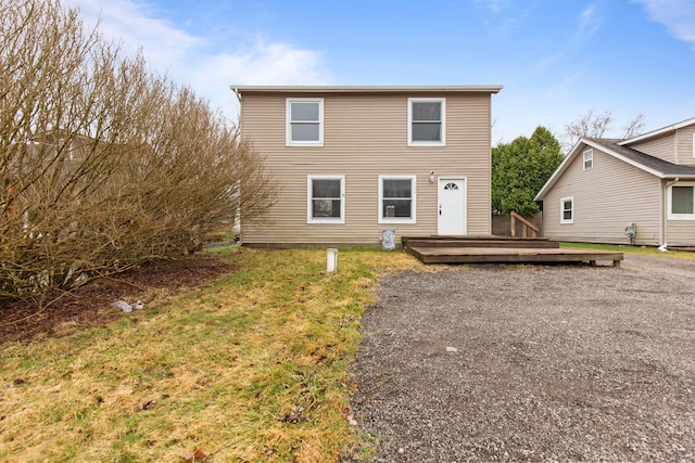 142 E Glass Rd, Ortonville, MI 48462 - back of house featuring a lawn and a wooden deck
