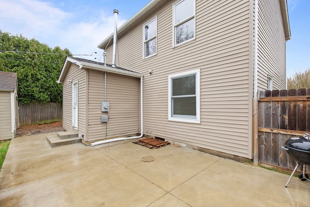142 E Glass Rd, Ortonville, MI 48462 - rear view of property featuring a patio, fence, and an outdoor structure