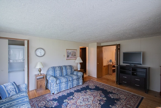 living area with a textured ceiling and wood finished floors