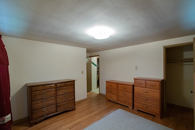 bedroom with baseboards and light wood-style flooring