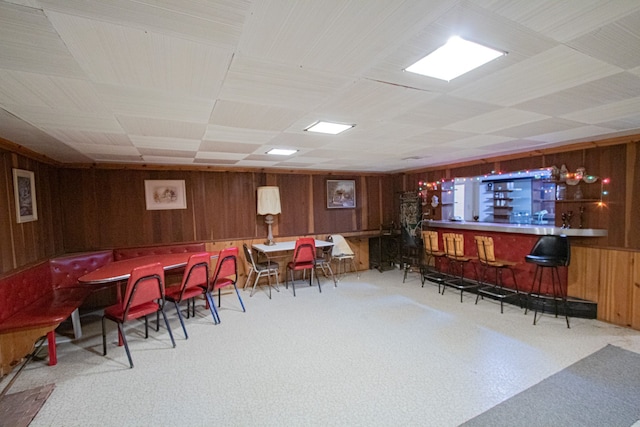 interior space with wooden walls and a dry bar