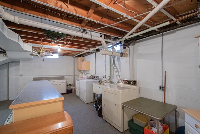 unfinished basement with independent washer and dryer and a sink