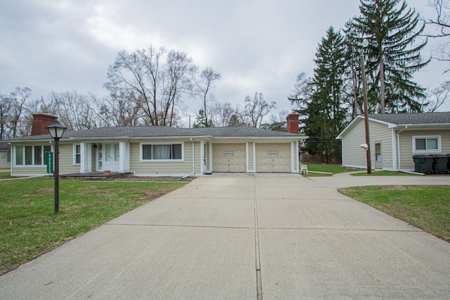 ranch-style home with a front lawn, driveway, a chimney, and a garage