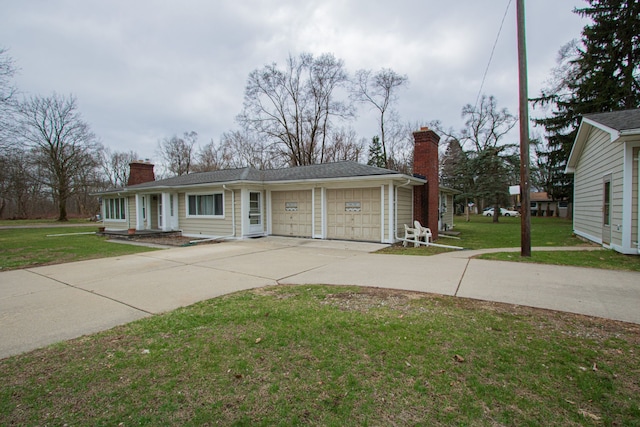 single story home with driveway, a chimney, a front lawn, and an attached garage
